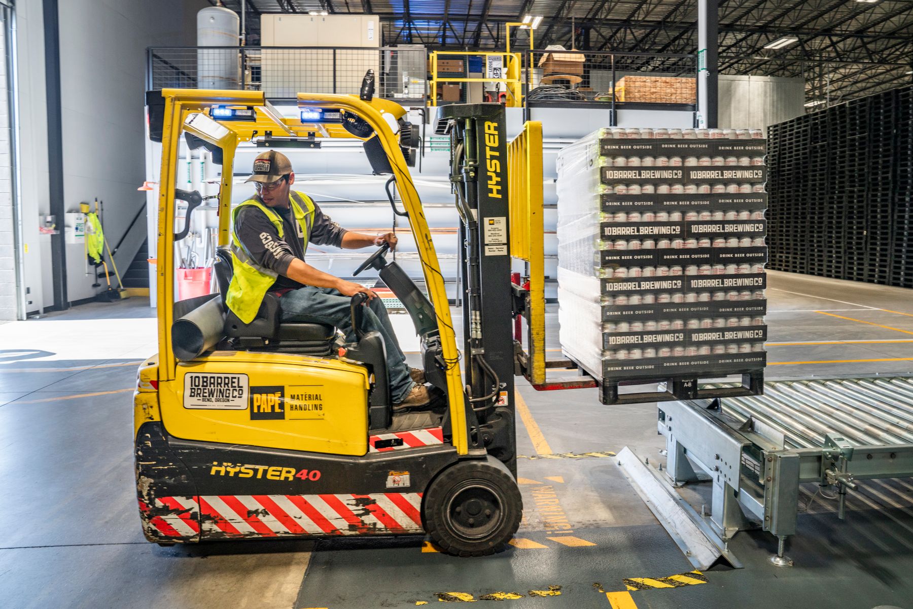 Warehouse aisles with pallet racking, illustrating equipment logistics.
